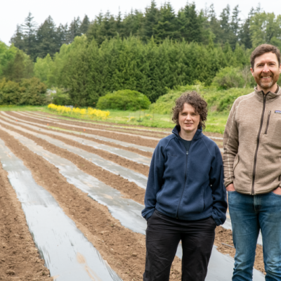 Dr. Matthew Mitchell (at right) and Laura Super stand near the research field where their work took place.